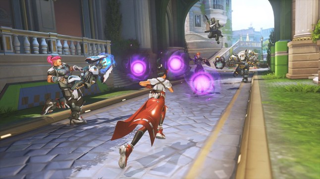 Overwatch 2 two teams of characters running towards each other while firing their weapons