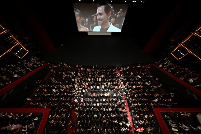 The crowd applauses at the end of the screening of the film "Emilia Perez" at the 77th edition of the Cannes Film Festival in Cannes, southern France, on May 18, 2024. (Photo by Antonin THUILLIER / AFP) (Photo by ANTONIN THUILLIER/AFP via Getty Images)