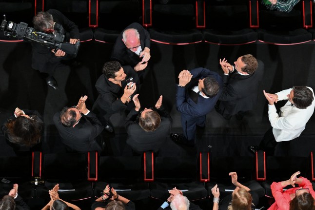 French actor Pierre Niney (3L) reacts past Cannes Film Festival director Thierry Fremaux (top) at the end of the screening of the film "Le Comte de Monte-Cristo" (The Count of Monte-Cristo) at the 77th edition of the Cannes Film Festival in Cannes, southern France, on May 22, 2024. (Photo by Antonin THUILLIER / AFP) (Photo by ANTONIN THUILLIER/AFP via Getty Images)
