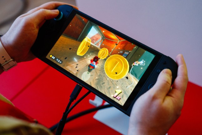 A guest plays Mario Kart World of the new Nintendo Switch 2 video-game console system of Japanese video-game company Nintendo during the worldwide presentation at the Grand Palais in Paris on April 2, 2025. Japanese video game giant Nintendo announced on April 2, 2025, that the new version of its Switch console would be launched on June 5, 2025. The Kyoto-based company also revealed new features for the Switch 2 -- an update to the 2017 original model -- including a new chat button that allows players to speak with each other while playing. (Photo by Dimitar DILKOFF / AFP) (Photo by DIMITAR DILKOFF/AFP via Getty Images)