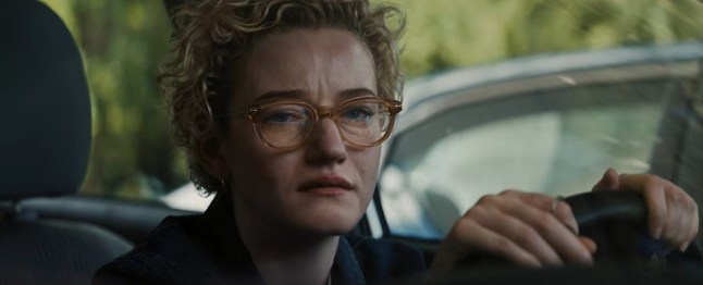 Julia Garner in Weapons crying while behind the wheel of a car