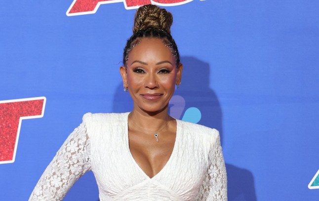Mel B in a white top and hair in a bun
