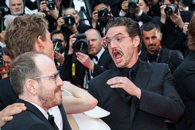 CANNES, FRANCE - MAY 16: (L-R) Ari Aster, Austin Butler, Emma Stone and Pedro Pascal react to a bee during the "Eddington" red carpet at the 78th annual Cannes Film Festival at Palais des Festivals on May 16, 2025 in Cannes, France. (Photo by Lyvans Boolaky/Getty Images)