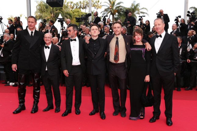 CANNES, FRANCE - MAY 18: Alexander Skarsg??rd, Ed Guiney, Lee Groombridge, Harry Melling, Harry Lighton, Emma Norton and Andrew Lowe attend the "The Phoenician Scheme" red carpet at the 78th annual Cannes Film Festival at Palais des Festivals on May 18, 2025 in Cannes, France. (Photo by Gisela Schober/Getty Images)