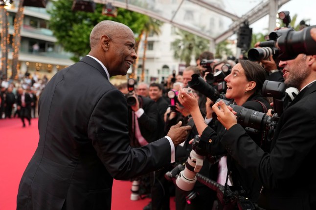 Denzel Washington poses for photographers upon arrival at the premiere of the film 'Highest 2 Lowest' at the 78th international film festival, Cannes, southern France, Monday, May 19, 2025. (AP Photo/Natacha Pisarenko)