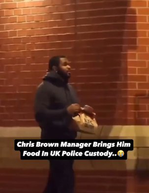 Uncleared grabs of Chris Brown's manager delivering KFC to him whilst he's in police custody, credit: Twiiter/@CrimeLdn