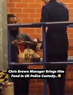 Uncleared grabs of Chris Brown's manager delivering KFC to him whilst he's in police custody, credit: Twiiter/@CrimeLdn